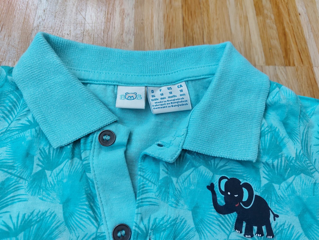 kurzärmliges türkises Polo-Shirt mit Palmenmuster Gr. 86